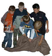 The blanket must be turned so that the underside is on the top without the players leaving the blanket.