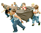 At the signal, the group holds up the blanket and races with player sitting on the blanket to the goal.